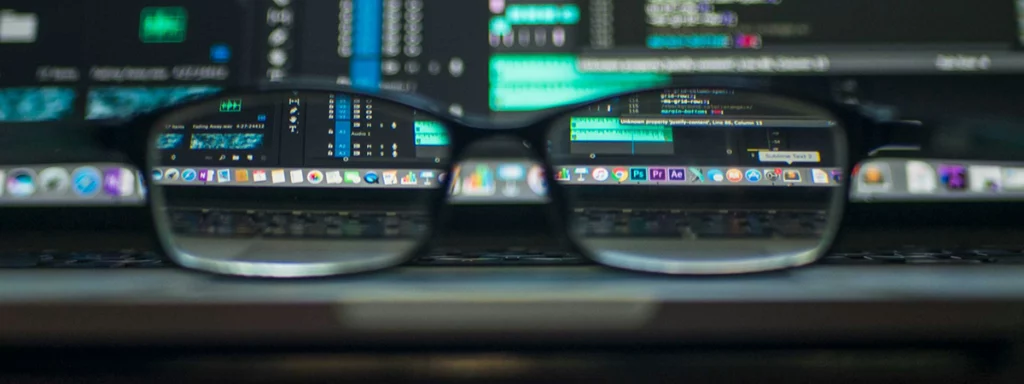 A pair of glasses bringing items on a computer into focus